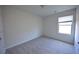 Neutral bedroom with a window and carpet flooring at 1560 Iris Walk, Jonesboro, GA 30238