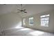 Primary bedroom with vaulted ceilings, ceiling fan, and three windows at 1560 Iris Walk, Jonesboro, GA 30238