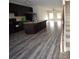 Open kitchen featuring a large island, dark cabinets, and hardwood floors at 1560 Iris Walk, Jonesboro, GA 30238