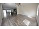 Open-concept living space featuring wood-like floors, a ceiling fan, and plenty of natural light at 1560 Iris Walk, Jonesboro, GA 30238