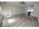 Spacious living area featuring a view of the stairs, wood-like flooring, and an open kitchen at 1560 Iris Walk, Jonesboro, GA 30238