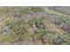 Aerial view of a wooded property featuring a cozy house near a scenic lake at 1791 Lake George Dr, Lithia Springs, GA 30122