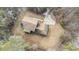 Aerial view of the home on a wooded lot with a circular driveway and back deck at 1791 Lake George Dr, Lithia Springs, GA 30122