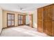 The bedroom has neutral carpet, a ceiling fan, and wood trim windows. Storage in the closet is abundant at 1791 Lake George Dr, Lithia Springs, GA 30122