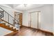The foyer showcases pristine white walls, wood-look floors, and a staircase with decorative black iron railing at 1791 Lake George Dr, Lithia Springs, GA 30122