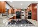 Well-lit kitchen features a granite countertop, updated appliances, and wood cabinets for all your storage needs at 1791 Lake George Dr, Lithia Springs, GA 30122