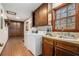 Spacious laundry room with ample storage and a large sink at 1791 Lake George Dr, Lithia Springs, GA 30122