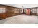 Living room with wood paneling, brick hearth, and carpeted floors at 1791 Lake George Dr, Lithia Springs, GA 30122