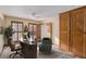 The well-lit office offers ample storage with a large wood cabinet and natural light from the surrounding windows at 1791 Lake George Dr, Lithia Springs, GA 30122
