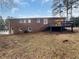 An expansive, fenced backyard features a deck and brick home exterior at 2240 Spalding Dr, Marietta, GA 30062