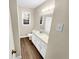 Bathroom features vinyl flooring, natural light, and white vanity with white cabinets at 2240 Spalding Dr, Marietta, GA 30062