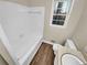 Bright bathroom featuring a tub with white tiled walls, and a wood look floor at 2240 Spalding Dr, Marietta, GA 30062