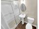 Bathroom features white pedestal sink, vinyl flooring, and a shower with glass doors at 2240 Spalding Dr, Marietta, GA 30062