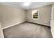 Carpeted bedroom features window and neutral walls, providing ample light at 2240 Spalding Dr, Marietta, GA 30062
