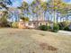 Charming brick home with a well-maintained front yard and mature trees at 2240 Spalding Dr, Marietta, GA 30062