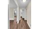 Hallway features hardwood flooring and neutral paint, leading to other rooms at 2240 Spalding Dr, Marietta, GA 30062