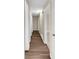 Hallway with hardwood flooring and neutral walls leading to other rooms at 2240 Spalding Dr, Marietta, GA 30062