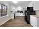 Bright kitchen featuring white cabinets and black appliances at 2240 Spalding Dr, Marietta, GA 30062