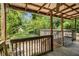 A covered wooden back porch area that looks out to a large grassy backyard at 3146 Alston Dr, Decatur, GA 30032
