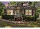 Charming single-story home featuring a cozy front porch and well-maintained landscaping at sunset at 3146 Alston Dr, Decatur, GA 30032