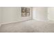 Spacious bedroom with a large window, neutral tones, and plush carpeting at 7004 Pat Mell Se Pl, Smyrna, GA 30080