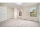 Well-lit bedroom with two windows offering natural light and neutral carpet at 7004 Pat Mell Se Pl, Smyrna, GA 30080