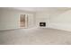 Bright living area with a white fireplace, a large window and a neutral carpet at 7004 Pat Mell Se Pl, Smyrna, GA 30080