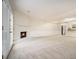 Open-concept living room featuring a fireplace, seamlessly connected to the kitchen, and neutral carpet at 7004 Pat Mell Se Pl, Smyrna, GA 30080