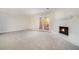 Comfortable living room with a cozy fireplace, French doors leading outside, and neutral carpet at 7004 Pat Mell Se Pl, Smyrna, GA 30080