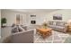 Inviting living room with a cozy fireplace, neutral tones, and ample seating, perfect for relaxation at 7004 Pat Mell Se Pl, Smyrna, GA 30080