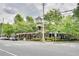 View of the exterior featuring brick facade, charming landscaping and mature trees at 1430 Dresden Ne Dr # 225, Atlanta, GA 30319