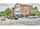 View of the brick building featuring outdoor dining under stylish blue awnings at 1430 Dresden Ne Dr # 225, Atlanta, GA 30319