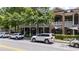 Exterior featuring elegant stone and brick facade, a covered porch, and mature trees at 1430 Dresden Ne Dr # 225, Atlanta, GA 30319