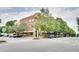 Exterior of the brick building, surrounded by lush trees and ample parking at 1430 Dresden Ne Dr # 225, Atlanta, GA 30319