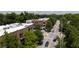 Aerial street view of Village Place showing commercial buildings nestled among lush trees and a clear road at 1430 Dresden Ne Dr # 225, Atlanta, GA 30319