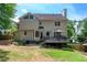 Back exterior view of home with deck and landscaping at 220 Galesburg Dr, Lawrenceville, GA 30044