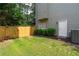 Backyard with a well-maintained lawn, wooden fence, and access door to the house at 220 Galesburg Dr, Lawrenceville, GA 30044