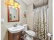 Bathroom with sink, wood vanity, toilet, and shower curtain at 220 Galesburg Dr, Lawrenceville, GA 30044
