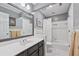 Bathroom featuring a vanity with sink, tub and shower with white tile at 220 Galesburg Dr, Lawrenceville, GA 30044