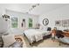 Well-lit bedroom with a comfortable bed, desk, and large windows at 220 Galesburg Dr, Lawrenceville, GA 30044