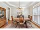 Bright dining room with elegant furnishings, hardwood floors, and a decorative chandelier at 220 Galesburg Dr, Lawrenceville, GA 30044