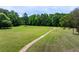 Lush green space featuring a walking path and bordered by mature trees in a serene setting at 220 Galesburg Dr, Lawrenceville, GA 30044