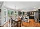 Eat-in kitchen with black cabinets, stainless steel appliances, and hardwood floors at 220 Galesburg Dr, Lawrenceville, GA 30044