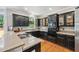 Kitchen with black cabinetry, stainless appliances, breakfast bar, and hardwood floors at 220 Galesburg Dr, Lawrenceville, GA 30044