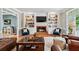 Bright living room with a fireplace, built-in shelving, and hardwood flooring at 220 Galesburg Dr, Lawrenceville, GA 30044