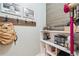 Mudroom with utility shelving, hooks, and stylish accent wall at 220 Galesburg Dr, Lawrenceville, GA 30044