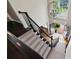 Elegant staircase with carpeted steps, black railing, and stylish chandelier at 220 Galesburg Dr, Lawrenceville, GA 30044