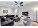 Bright living room featuring a plush sectional sofa, stylish decor, and a modern ceiling fan for added comfort at 400 17Th Nw St # 1119, Atlanta, GA 30363