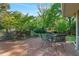 Picturesque backyard with a brick patio, outdoor dining area, and mature trees at 4261 Brookview Se Dr, Atlanta, GA 30339
