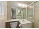 Cozy bathroom features a shower, commode and vanity with neutral toned patterned wallpaper at 4261 Brookview Se Dr, Atlanta, GA 30339